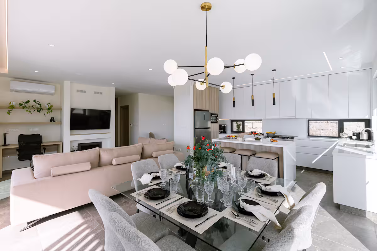 Open-plan dining area with a set table, lounge and kitchen island