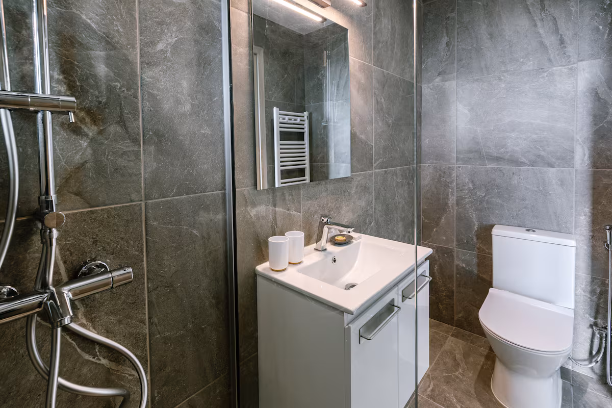 Bathroom with a walk-in shower, vanity and toilet